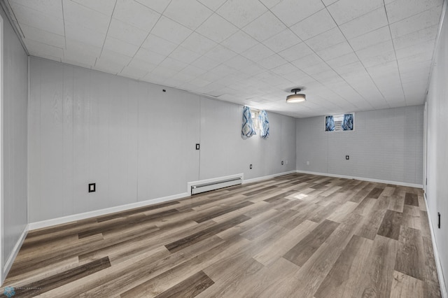 3113 8th St N, Fargo, ND 58102 - below grade area with a baseboard heating unit and wood finished floors