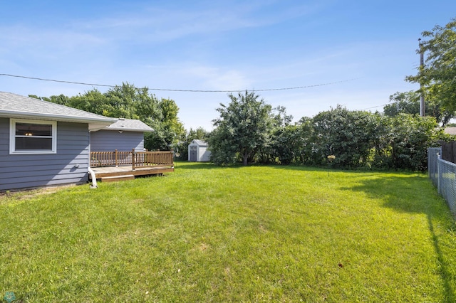 3113 8th St N, Fargo, ND 58102 - view of yard featuring a storage shed and a wooden deck