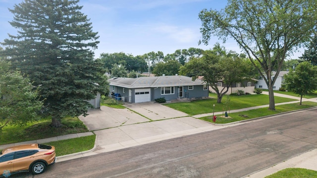 3113 8th St N, Fargo, ND 58102 - ranch-style house with an attached garage, driveway, and a front yard