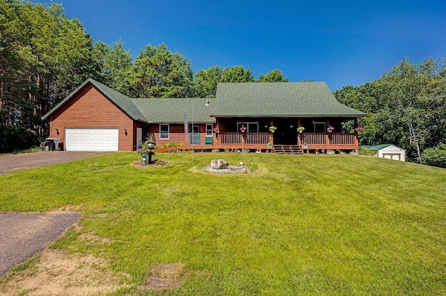 417 Whiskey Rd SW, Isanti, MN 55040 - cabin with an attached garage, a front yard, driveway, and a shed