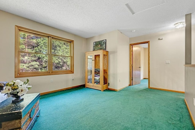 417 Whiskey Rd SW, Isanti, MN 55040 - empty room featuring carpet flooring, a textured ceiling, and attic access