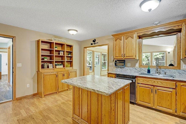 417 Whiskey Rd SW, Isanti, MN 55040 - kitchen with dishwasher, light wood-style floors, a kitchen island, a textured ceiling, and brown cabinets