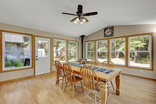 417 Whiskey Rd SW, Isanti, MN 55040 - dining space featuring light wood-style flooring, vaulted ceiling, ceiling fan, and a textured ceiling