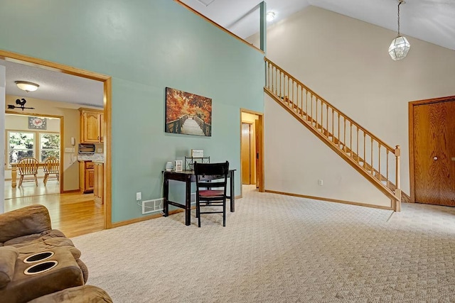 417 Whiskey Rd SW, Isanti, MN 55040 - living room featuring stairs, high vaulted ceiling, and light colored carpet