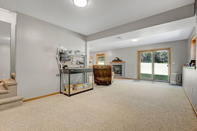 417 Whiskey Rd SW, Isanti, MN 55040 - living area with carpet flooring, stairway, plenty of natural light, and a glass covered fireplace