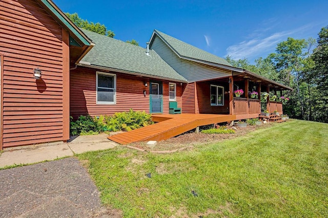 417 Whiskey Rd SW, Isanti, MN 55040 - back of house with roof with shingles, a yard, and a wooden deck