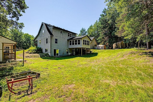 417 Whiskey Rd SW, Isanti, MN 55040 - rear view of house featuring a garden and a sunroom