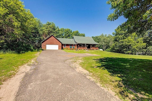 417 Whiskey Rd SW, Isanti, MN 55040 - view of front of property featuring a porch, an attached garage, a front yard, and driveway