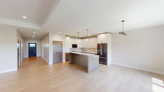 2330 9th St W, Albert Lea, MN 56007 - kitchen featuring high end refrigerator, light countertops, recessed lighting, light wood-style floors, and a kitchen island with sink