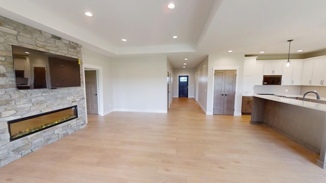 2330 9th St W, Albert Lea, MN 56007 - kitchen featuring stainless steel microwave, recessed lighting, a fireplace, open floor plan, and white cabinets