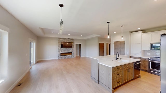 2330 9th St W, Albert Lea, MN 56007 - kitchen with stainless steel appliances, light countertops, recessed lighting, light wood-style floors, and hanging light fixtures
