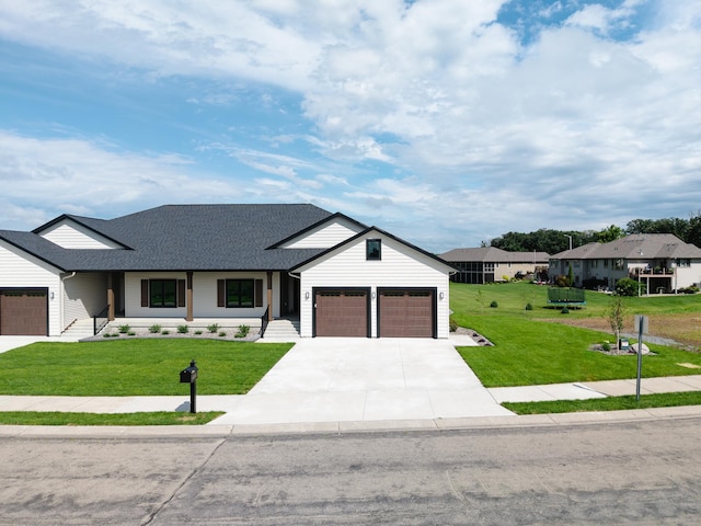 2330 9th St W, Albert Lea, MN 56007 - modern farmhouse with a front lawn, roof with shingles, concrete driveway, and a garage