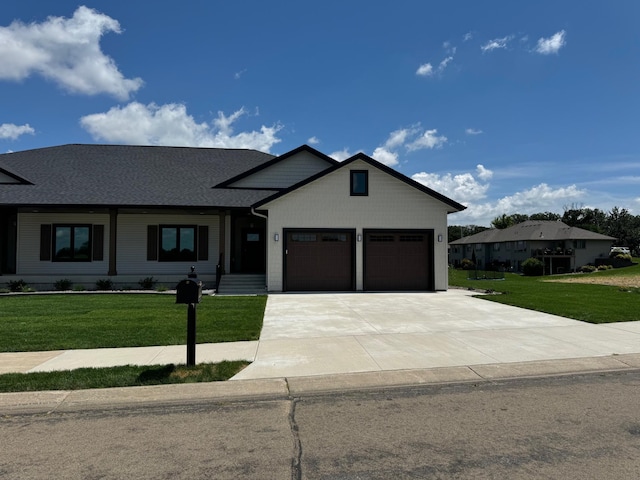 2330 9th St W, Albert Lea, MN 56007 - view of front of home with driveway, a front lawn, an attached garage, and roof with shingles