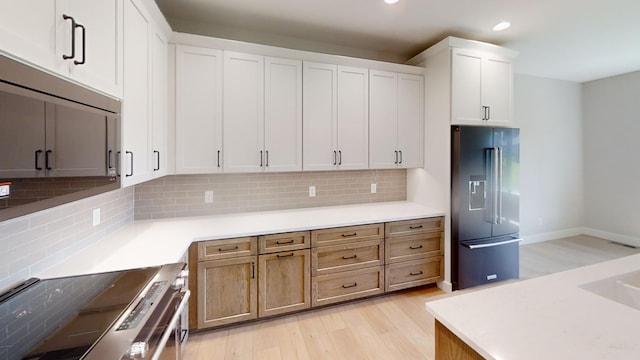 2330 9th St W, Albert Lea, MN 56007 - kitchen featuring high end fridge, stainless steel range with electric cooktop, recessed lighting, light wood-style flooring, and backsplash