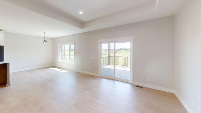 2330 9th St W, Albert Lea, MN 56007 - spare room with light wood-type flooring, a raised ceiling, and recessed lighting