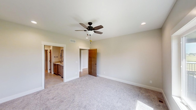 2330 9th St W, Albert Lea, MN 56007 - unfurnished bedroom with light carpet, recessed lighting, connected bathroom, and ceiling fan