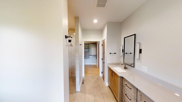 2330 9th St W, Albert Lea, MN 56007 - bathroom with tiled shower, vanity, tile patterned flooring, and recessed lighting