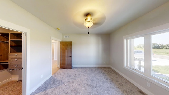 2330 9th St W, Albert Lea, MN 56007 - spare room with healthy amount of natural light, light colored carpet, and a ceiling fan