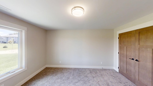 2330 9th St W, Albert Lea, MN 56007 - unfurnished bedroom with carpet and multiple windows