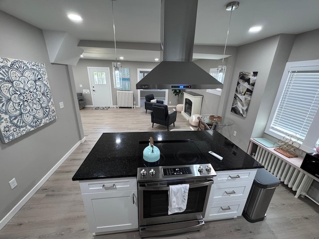 4644 Lyndale Ave S, Minneapolis, MN 55419 - kitchen with stainless steel electric range, island range hood, radiator, open floor plan, and white cabinets