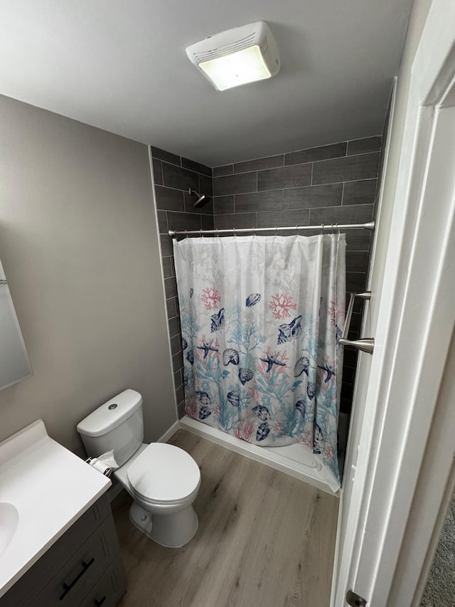 4644 Lyndale Ave S, Minneapolis, MN 55419 - full bath featuring vanity, wood finished floors, and tiled shower