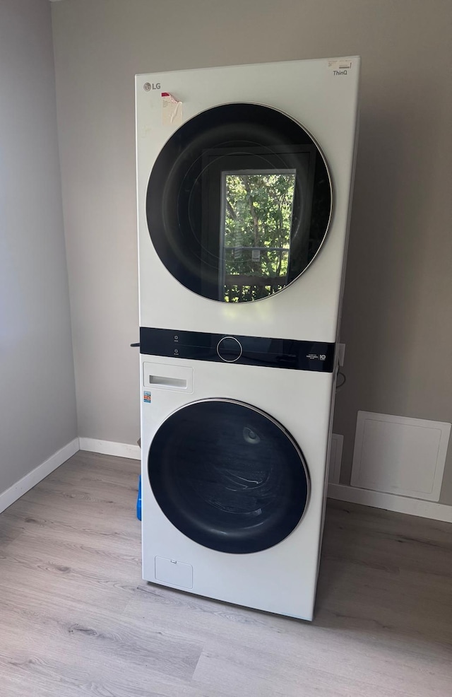 4644 Lyndale Ave S, Minneapolis, MN 55419 - laundry area with stacked washing machine and dryer and wood finished floors