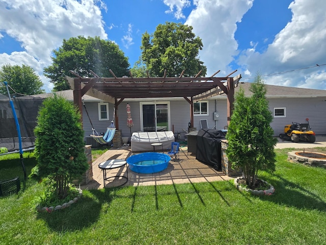 1101 7th Ave SW, Pipestone, MN 56164 - back of house with a trampoline, a patio, a lawn, and a pergola