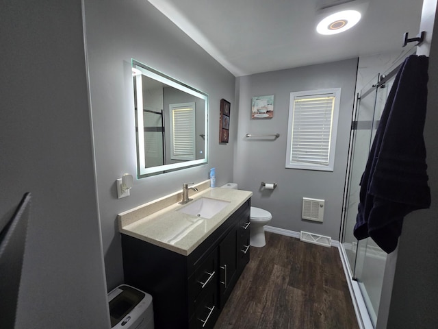 1101 7th Ave SW, Pipestone, MN 56164 - bathroom with vanity, wood finished floors, and a shower stall