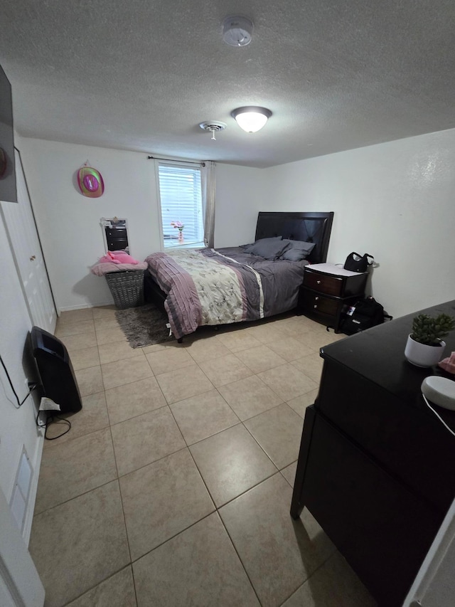 1101 7th Ave SW, Pipestone, MN 56164 - bedroom with light tile patterned floors and a textured ceiling