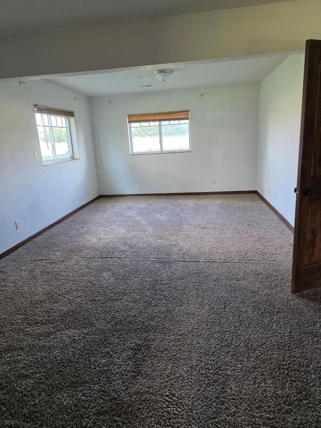 1719 Grand Ave, Worthington, MN 56187 - spare room featuring carpet and baseboards