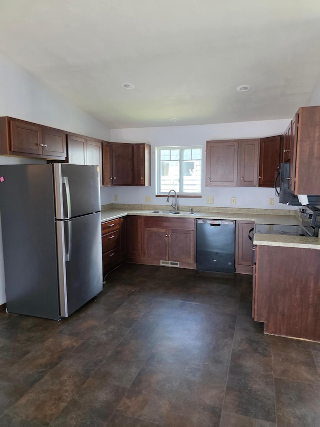 1719 Grand Ave, Worthington, MN 56187 - kitchen featuring freestanding refrigerator, dishwasher, black microwave, light countertops, and vaulted ceiling