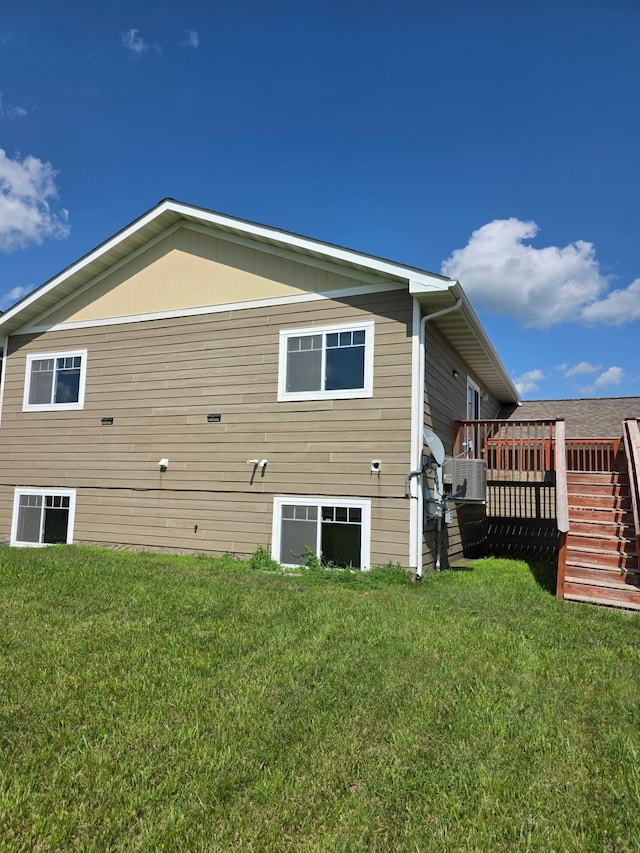 1719 Grand Ave, Worthington, MN 56187 - view of side of home with a deck, a yard, and stairway