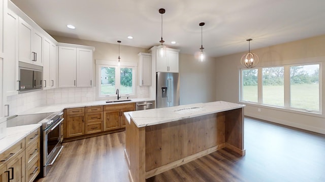 2329 9th St W, Albert Lea, MN 56007 - kitchen with high quality appliances, wood finished floors, decorative backsplash, recessed lighting, and a center island