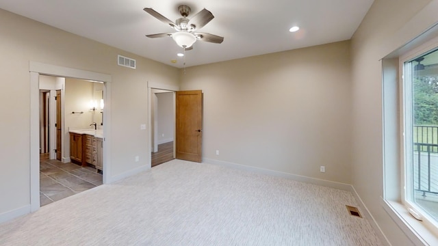 2329 9th St W, Albert Lea, MN 56007 - unfurnished bedroom with light carpet, recessed lighting, a ceiling fan, and connected bathroom