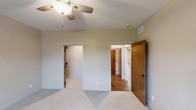 2329 9th St W, Albert Lea, MN 56007 - unfurnished bedroom with a spacious closet, carpet, and ceiling fan