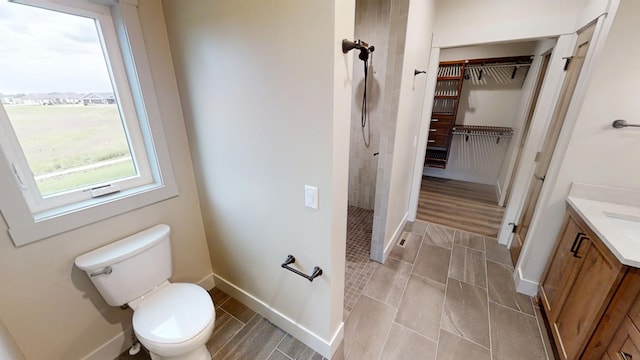2329 9th St W, Albert Lea, MN 56007 - full bathroom with vanity, a tile shower, and a walk in closet