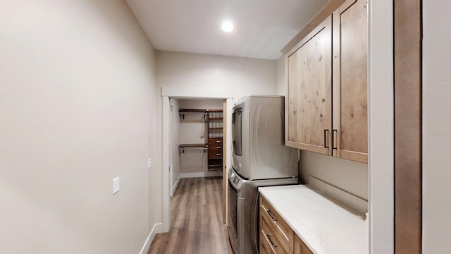 2329 9th St W, Albert Lea, MN 56007 - laundry area featuring cabinet space, light wood-type flooring, and stacked washer / dryer