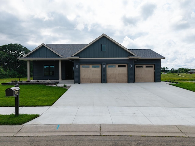 2329 9th St W, Albert Lea, MN 56007 - view of front facade with a front lawn, a garage, covered porch, driveway, and board and batten siding