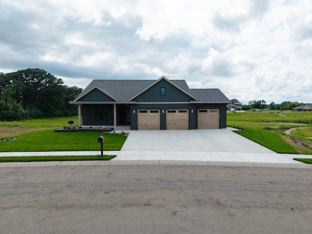 2329 9th St W, Albert Lea, MN 56007 - view of front of property featuring an attached garage, a front lawn, driveway, and board and batten siding