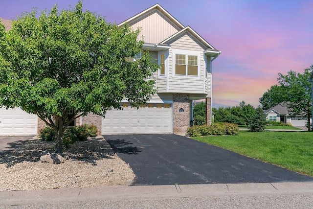 9742 Saint Andrews Dr, Elko New Market, MN 55020 - view of front of house with brick siding, asphalt driveway, a garage, and a front lawn