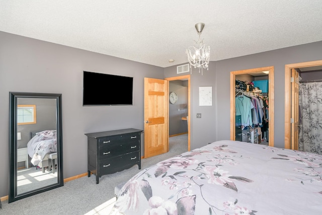 9742 Saint Andrews Dr, Elko New Market, MN 55020 - carpeted bedroom featuring a chandelier, a textured ceiling, and a walk in closet