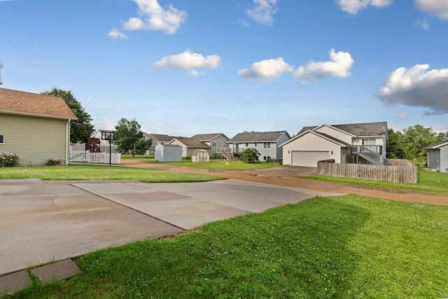 2112 York St, Saint Peter, MN 56082 - view of yard featuring a residential view, driveway, and a garage