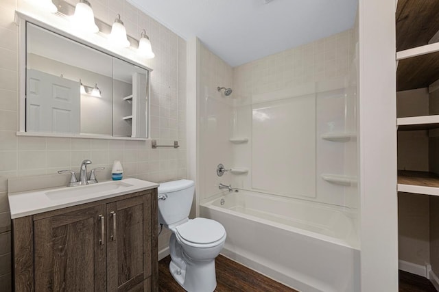 2112 York St, Saint Peter, MN 56082 - bathroom with tile walls, vanity, wood finished floors, bathtub / shower combination, and tasteful backsplash