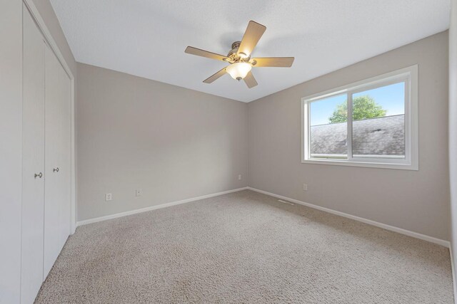 2112 York St, Saint Peter, MN 56082 - unfurnished bedroom with a closet, carpet floors, and ceiling fan