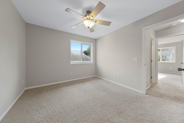 2112 York St, Saint Peter, MN 56082 - spare room featuring carpet, plenty of natural light, a ceiling fan, and a textured ceiling