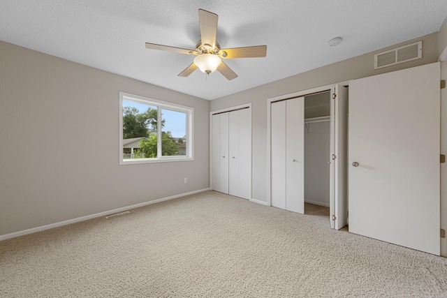 2112 York St, Saint Peter, MN 56082 - unfurnished bedroom featuring two closets, carpet, and a ceiling fan