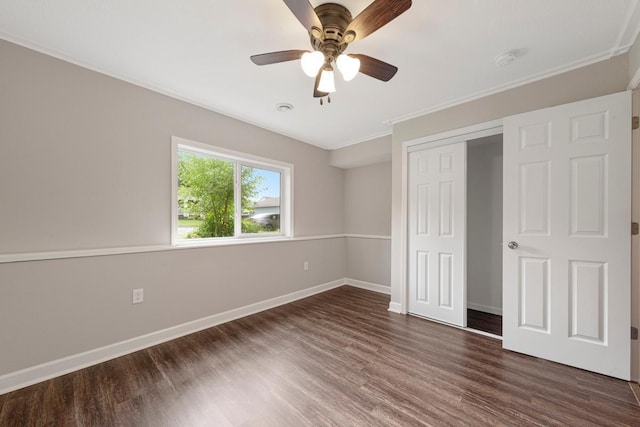2112 York St, Saint Peter, MN 56082 - unfurnished bedroom with dark wood-style flooring, a closet, crown molding, and ceiling fan
