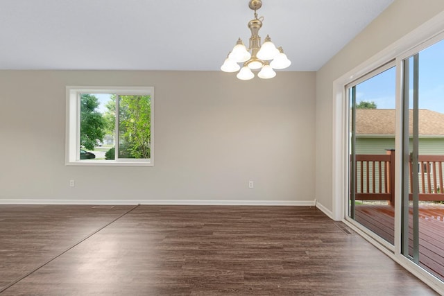 2112 York St, Saint Peter, MN 56082 - spare room featuring plenty of natural light, a chandelier, and wood finished floors