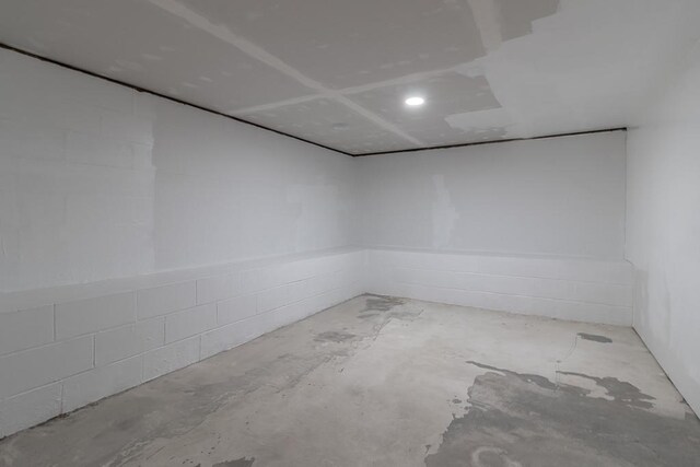 385 Lexington Ave, Le Center, MN 56057 - spare room with concrete block wall and concrete floors