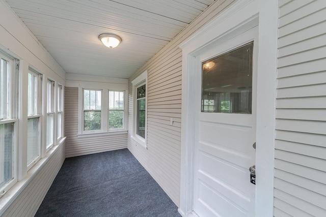 2156 Saint Anthony Ave, Saint Paul, MN 55104 - unfurnished sunroom with carpet and wood walls